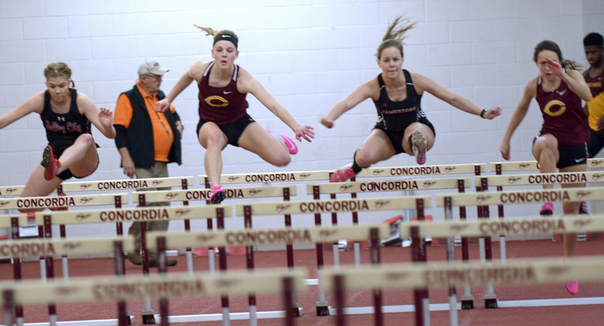 Runners jump out of the gate during the prelims of the 60-meter hurdles at the season-opening Cobber Open.