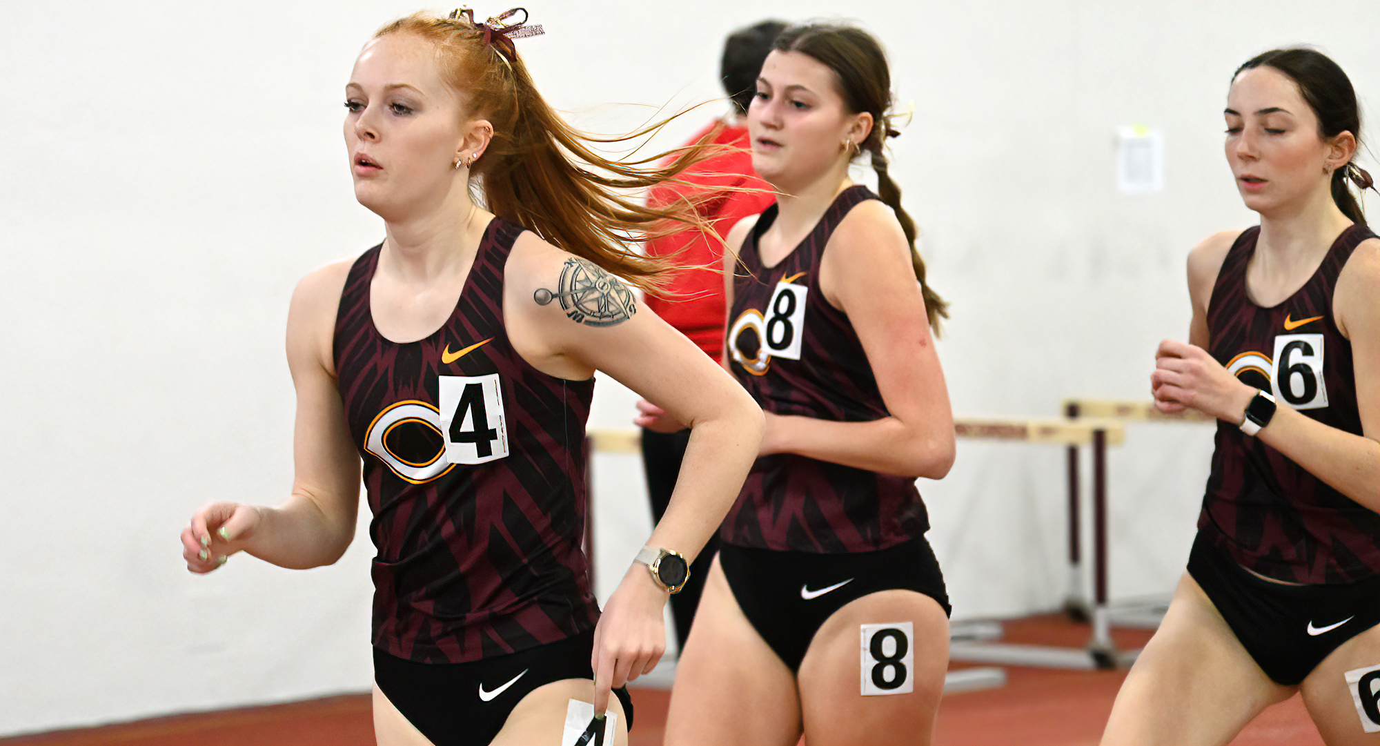 Airial Johnson (L) leads a trio of Cobber runners in the mile at the Cobber Open. Johnson won the event with a personal-best time of 5:49.93.
