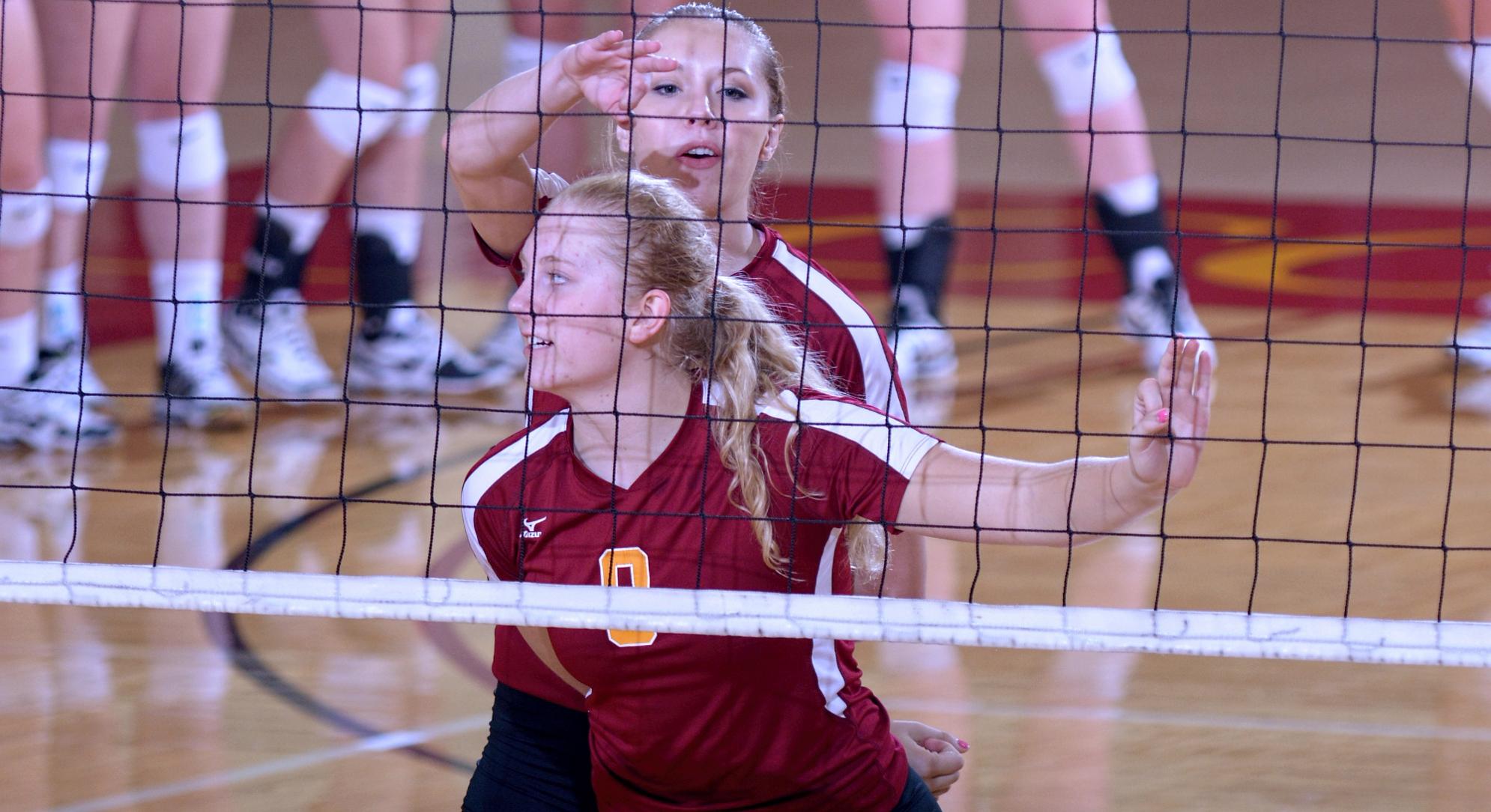 Brianna Carney (foreground) hit .520 and had a match-high 15 kills while Haley Cuppett (background) added 12 winners and hit .200 in the Cobbers' 3-1 win over St. Olaf.