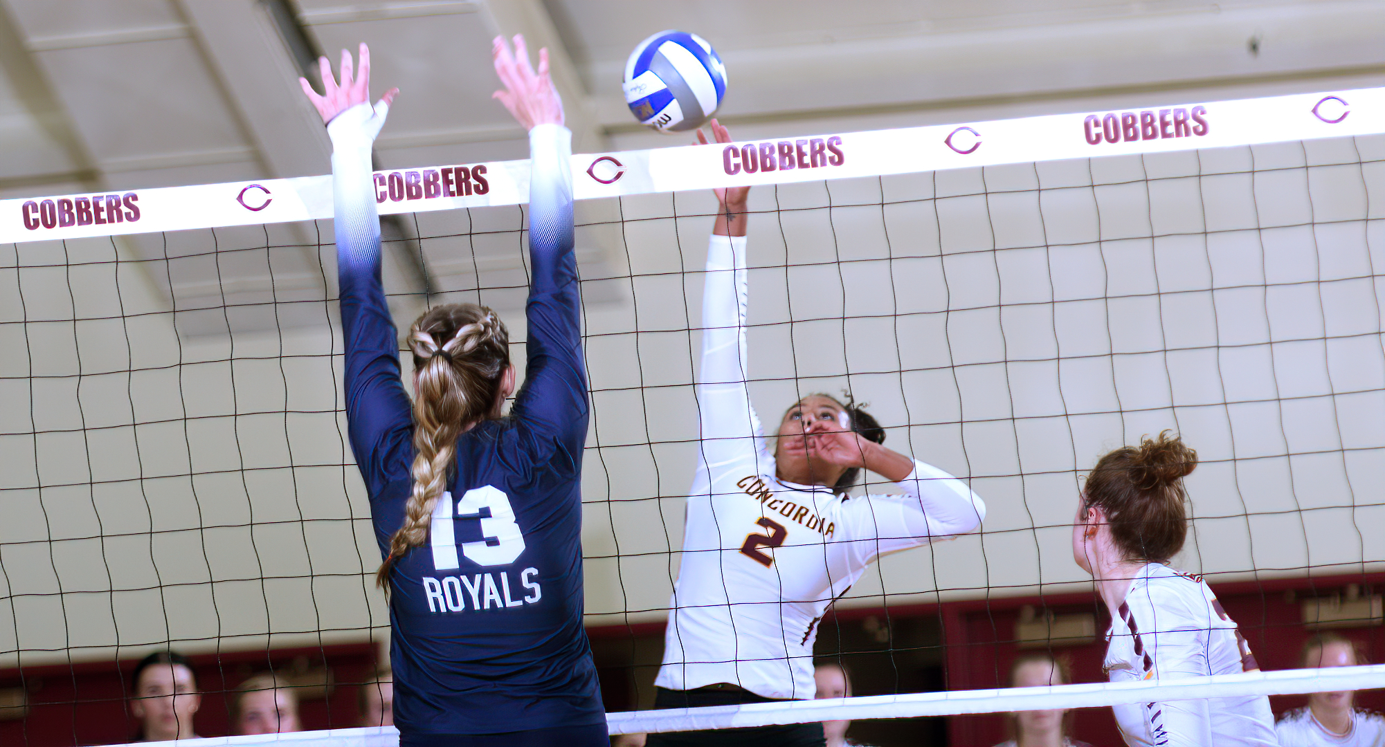 Anna Brakke tips the ball past the Bethel blocker during the Cobbers' match with the Royals. Brakke had a match-high 11 kills and added 11 digs.