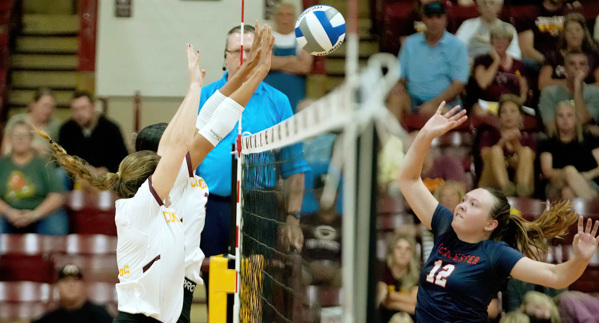 Samantha VanHeel (L) and Megan Olson go for the block at the net in the Cobbers' home opener against Macalester.