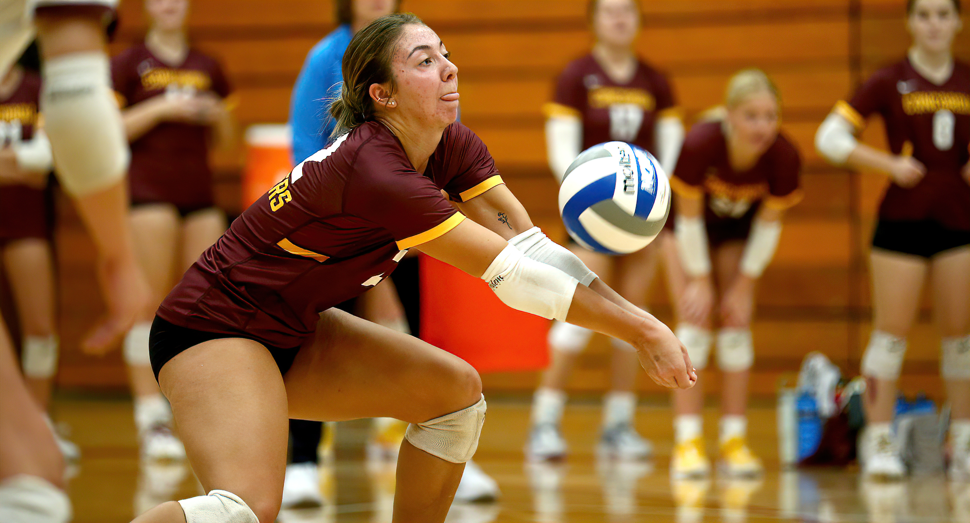 Cayla Sailer makes one of her team-high 12 digs in the Cobbers' match at Hamline. (Photo courtesy of D3photography.com)