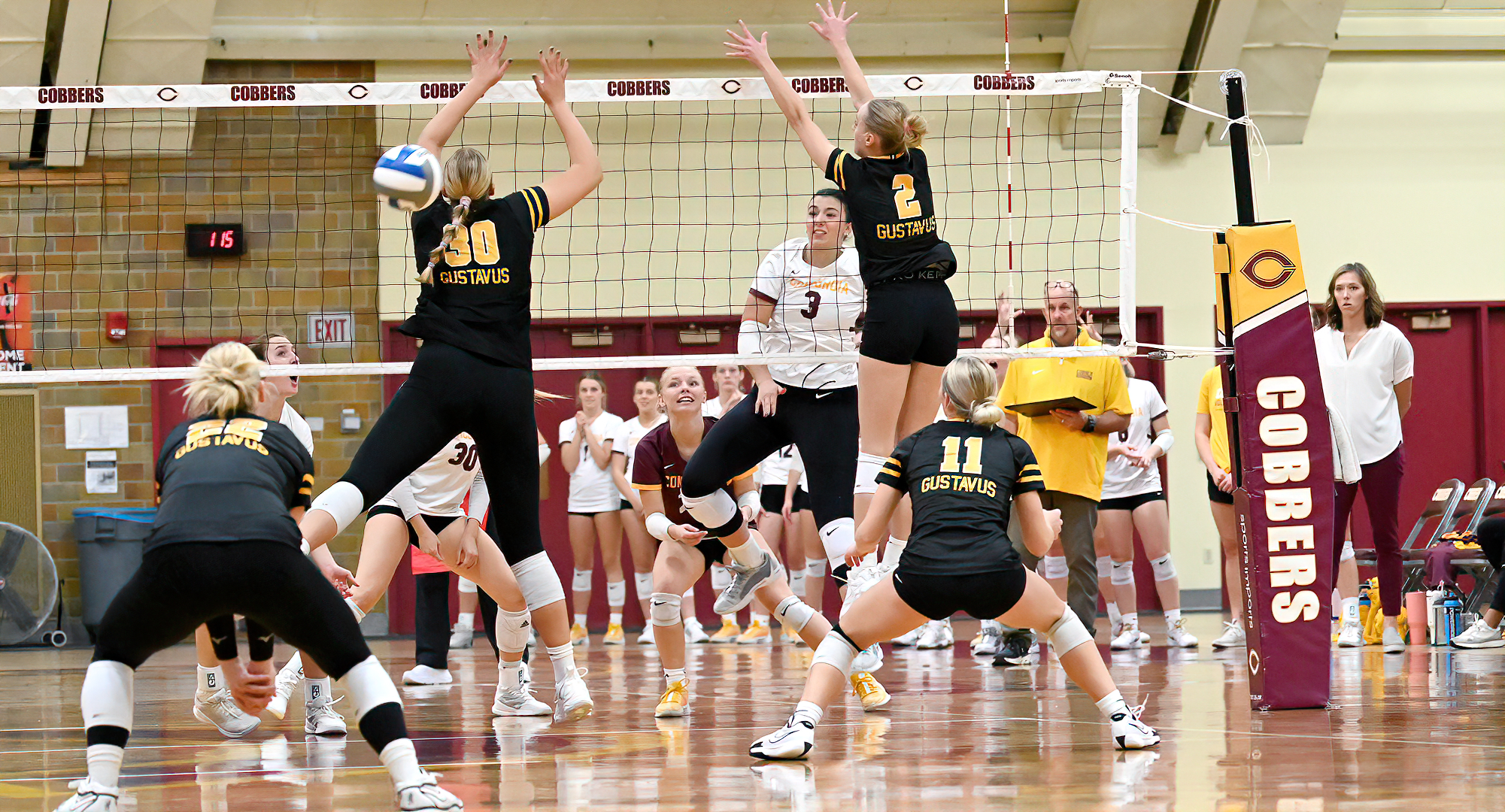 Mallory Leitner hits the ball through the block of the Gustavus front-line players. She finished with a team-high eight kills.