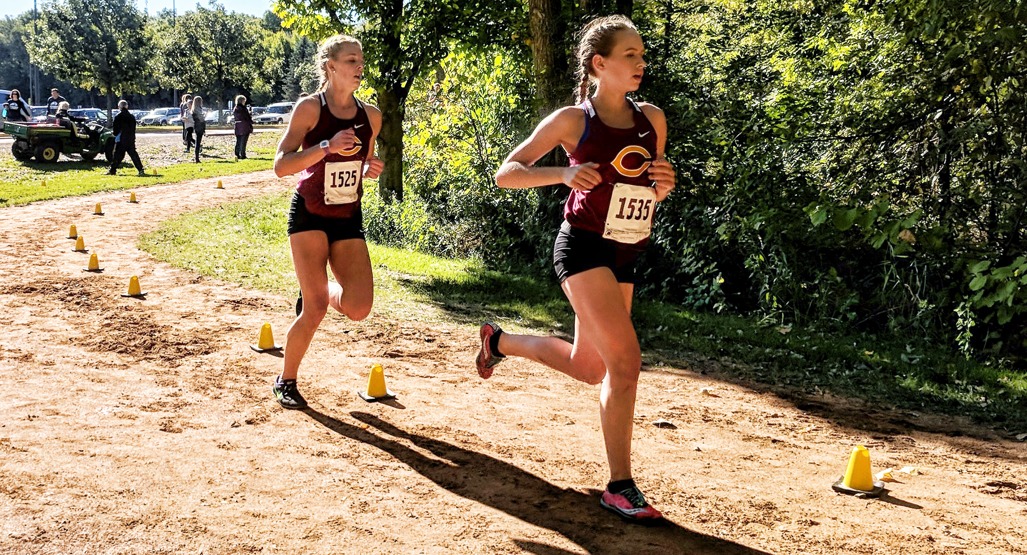 Freshman Kaitlyn Rooney leads teammate Carly Fornshell around the corner at the St. Olaf Invite.