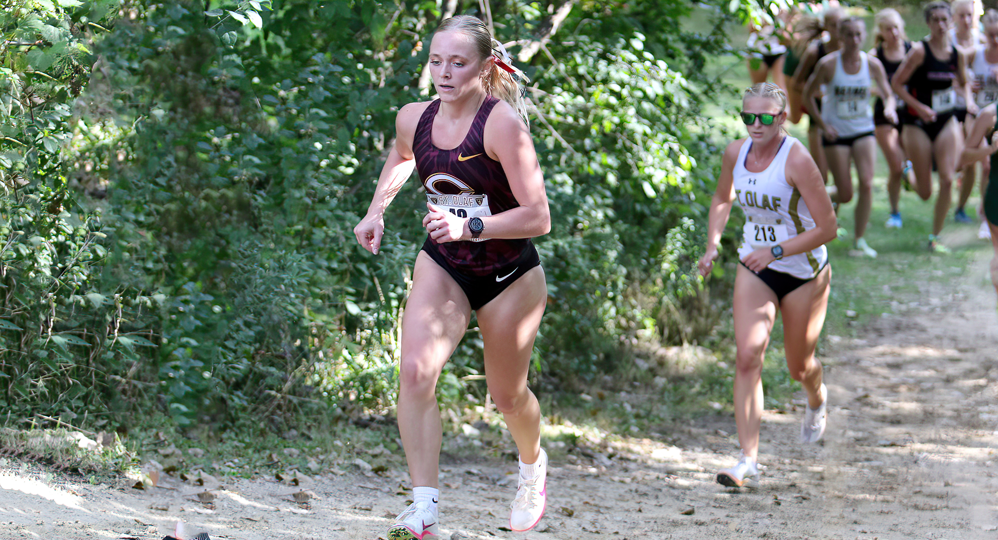 Senior Drew Frolek races up a hill at the St. Olaf Invite. Here late-race kick made her the No.1 finisher for CC. (Photo courtesy of Don Stoner)