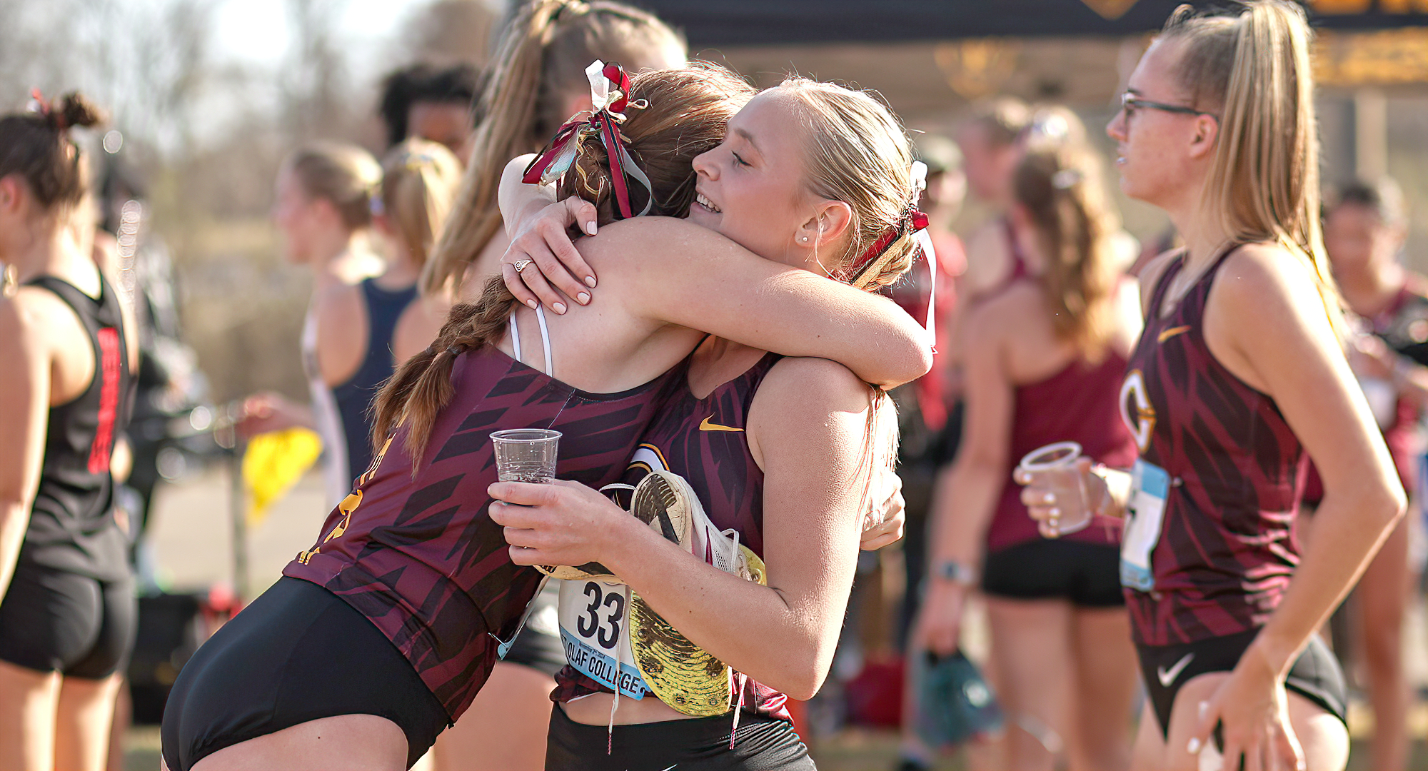 Senior Drew Frolek embraces a teammate after leading the Cobbers at the MIAC Championship Meet (Photo courtesy of the St. Olaf SID)