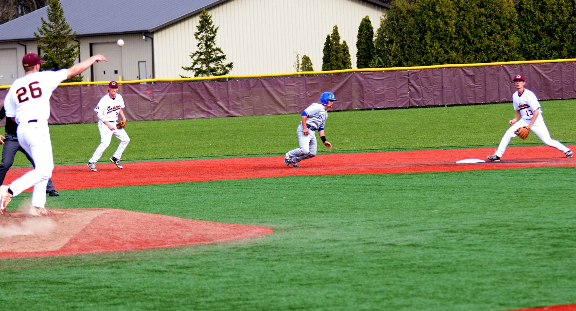 Cobber pitcher Turner Storm wheels and fires a pickoff throw to second baseman Nate Sillerud during the Cobbers' final non-conference game vs. Mayville State.