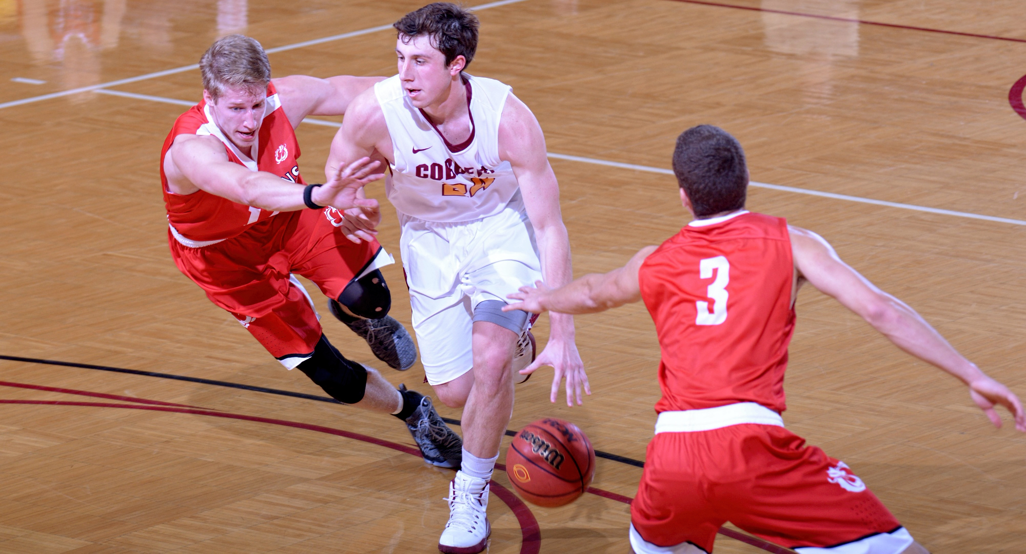 Cobber senior Austin Nelson dribbles by former high school teammate Aaron Lien on his way to the basket in Concordia's game with MSU Moorhead.