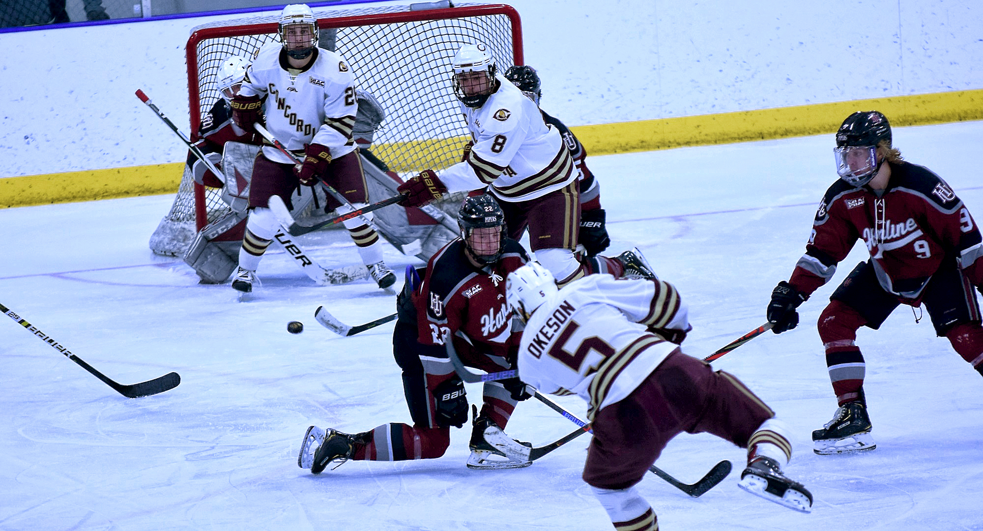 Senior Tanner Okeson fires one of his game-high six shots on goal in the second period of the Cobbers' win over Hamline. Teammates Aaron Herdt (#8) and Quinn Fuchs wait in front of the Piper goal.