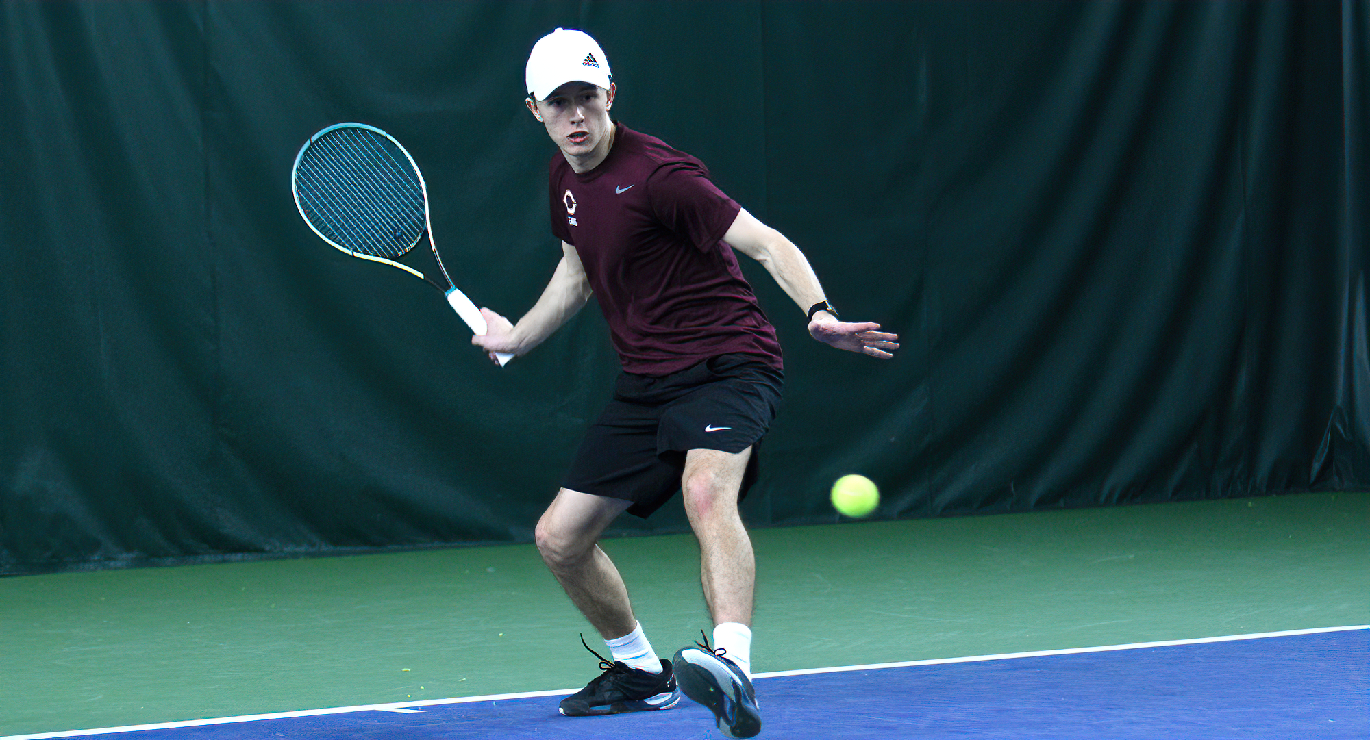 Freshman Logan Sandberg reaches for the forehand during his thrilling, super-set match at No.1 singles against UW-Superior.