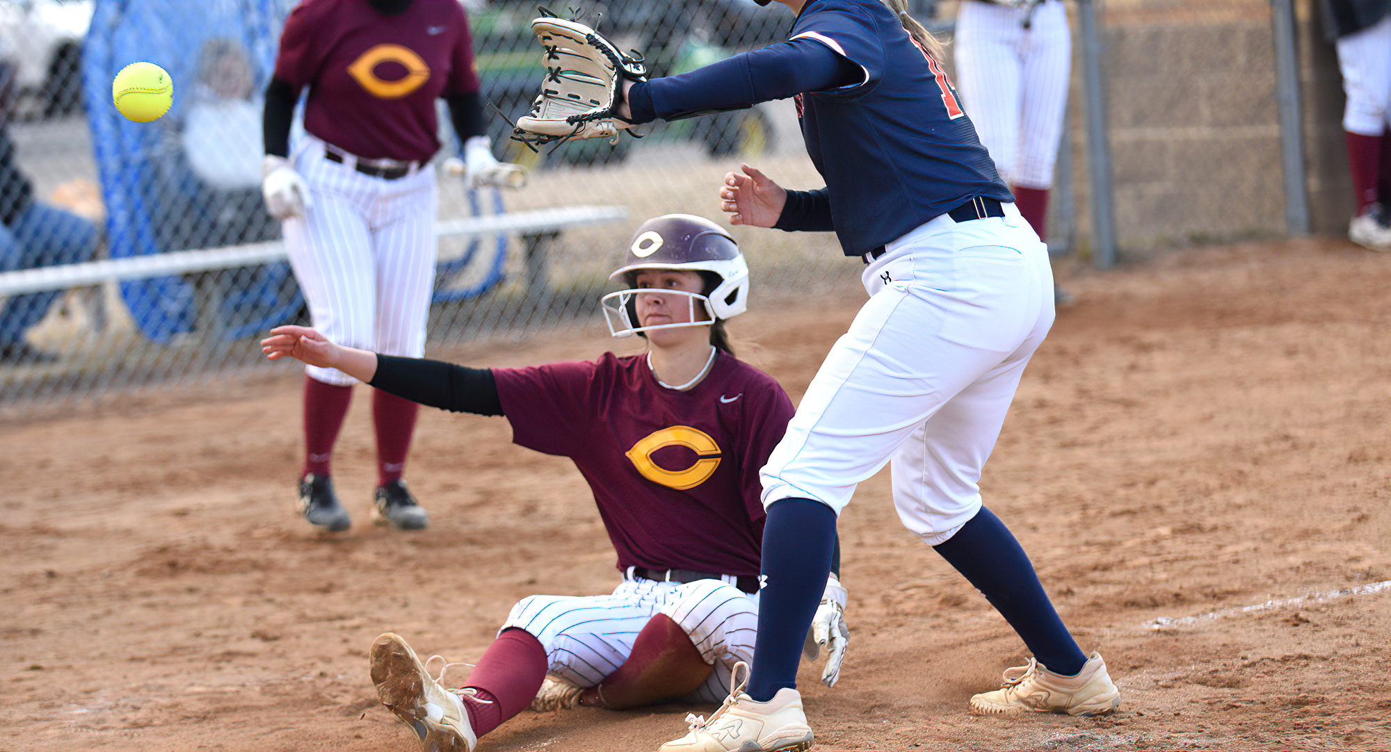 Reese Hauck slides into home after scoring on a wild pitch in the second inning of Game 2 in the Cobbers' doubleheader against Macalester.