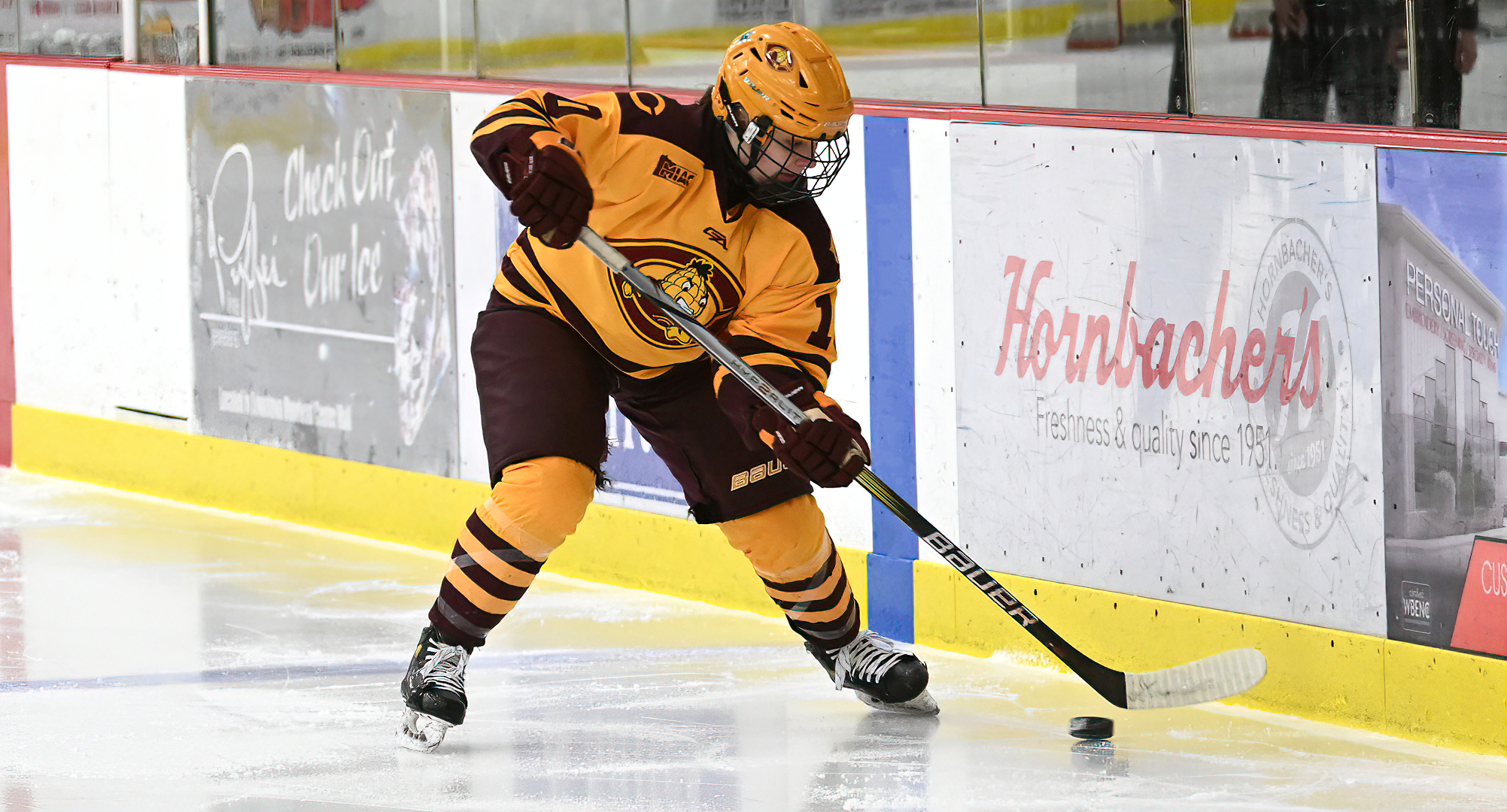 Lila Lanctot controls the puck before setting up the first goal in the Cobbers' game with Hamline. She scored her first college goal later in the game.