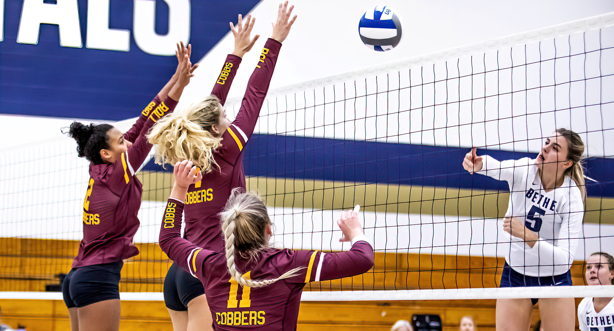 Senior Anna Brakke (L) and freshman Maria Watt go for the block during the Cobbers' conference road match at Bethel. (Photo courtesy of Bethel SID)